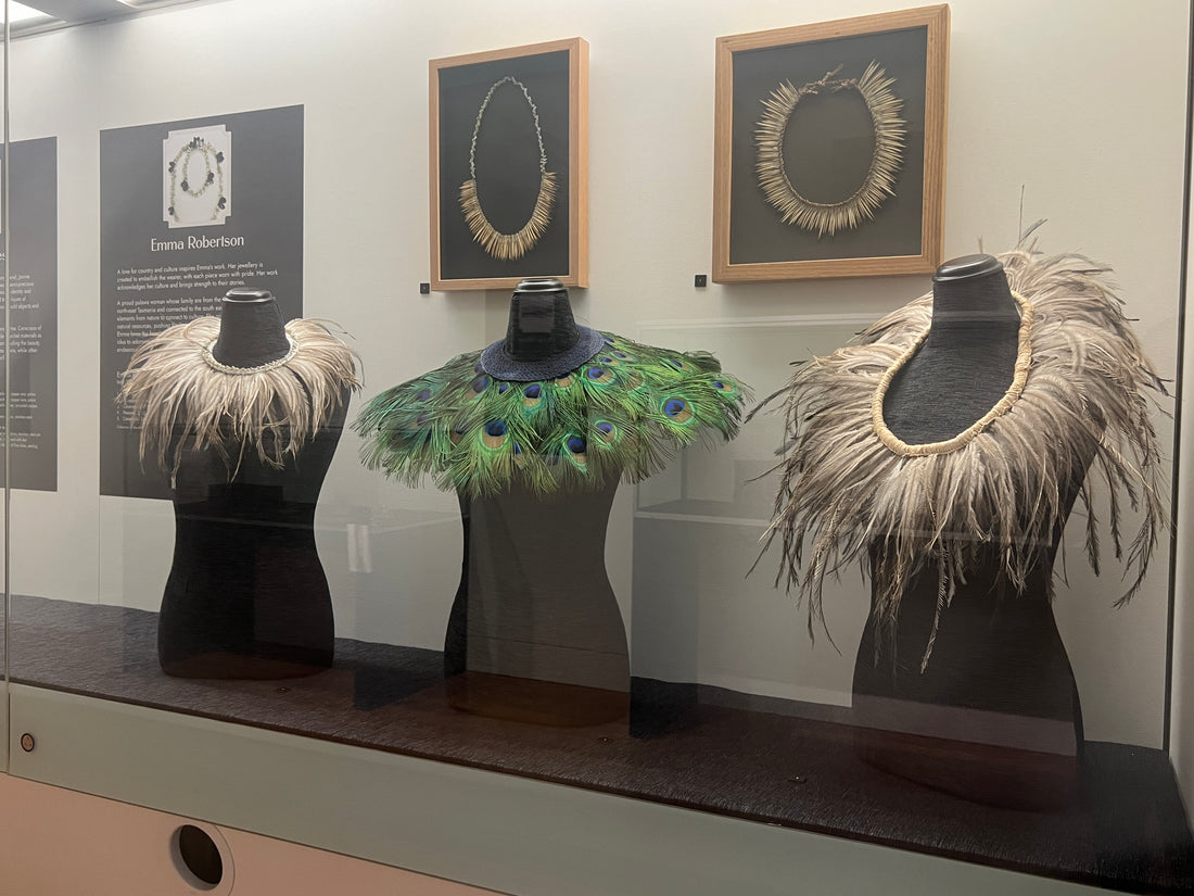 image of 5 necklaces in glass case.