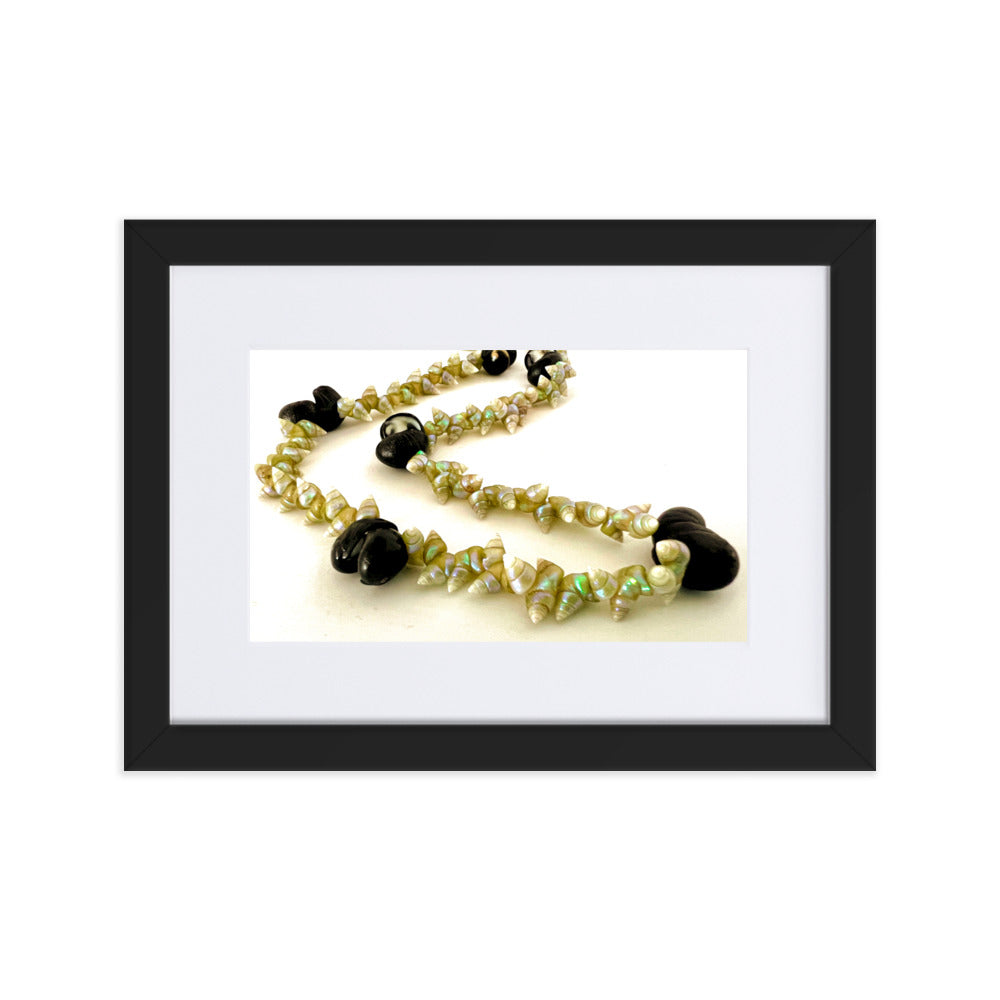 Beautiful green maireener and black crow shell necklace on white background.