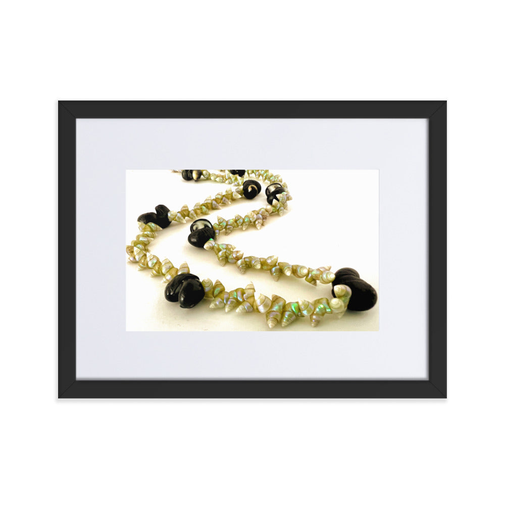Beautiful green maireener and black crow shell necklace on white background.