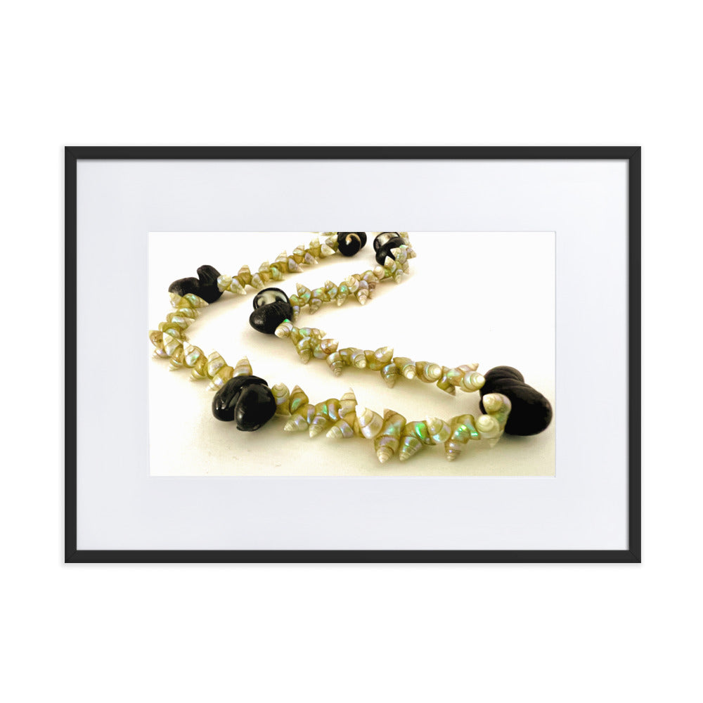 Beautiful green maireener and black crow shell necklace on white background.