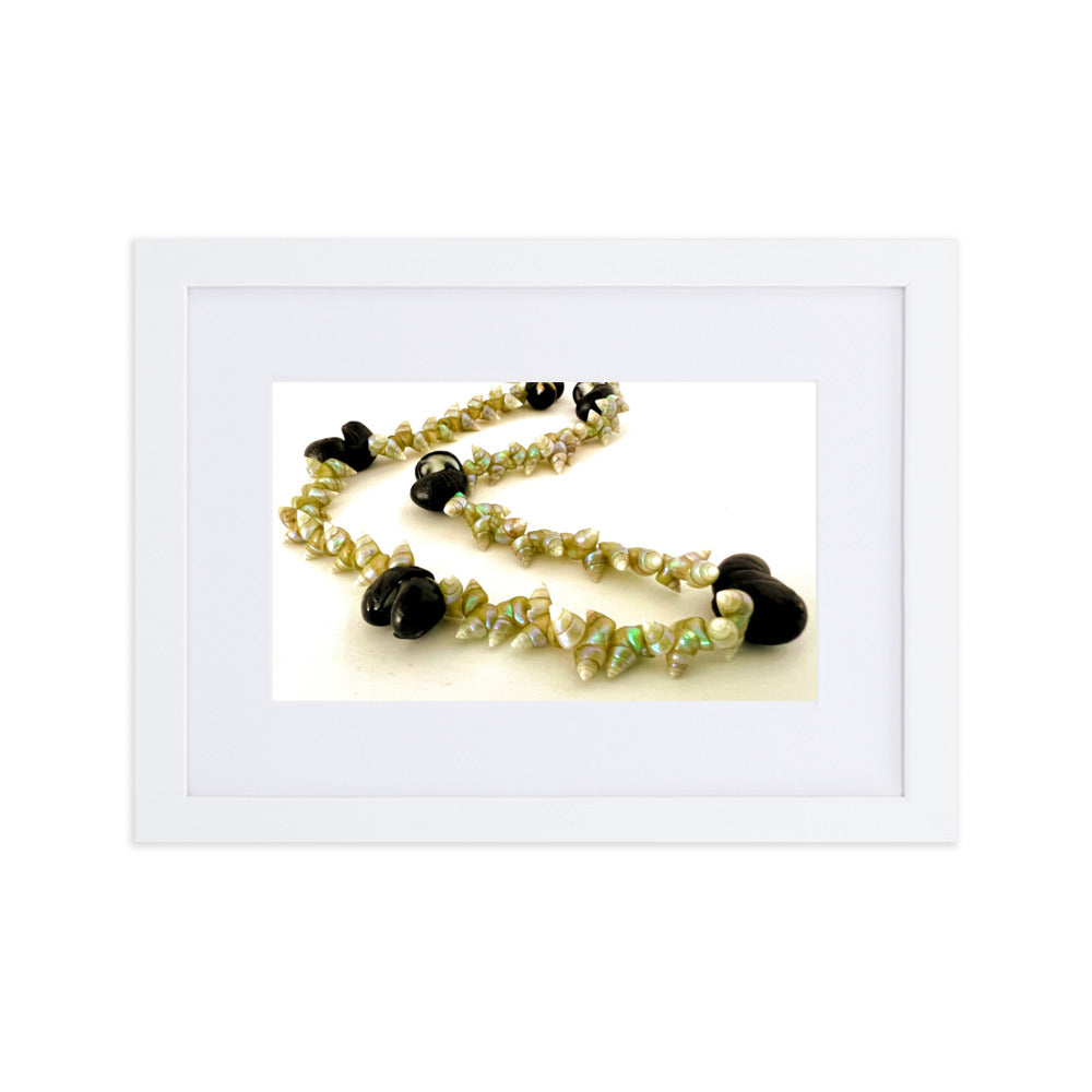 Beautiful green maireener and black crow shell necklace on white background.