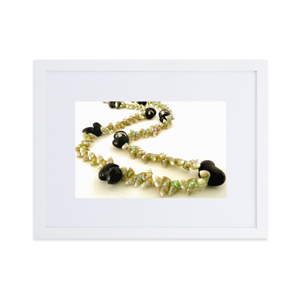 Beautiful green maireener and black crow shell necklace on white background.