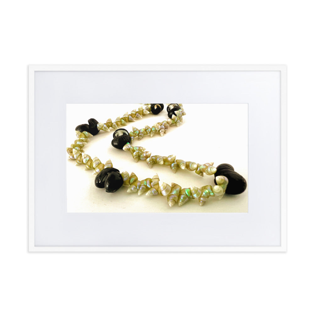 Beautiful green maireener and black crow shell necklace on white background.
