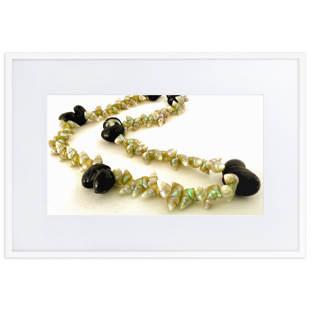 Beautiful green maireener and black crow shell necklace on white background.