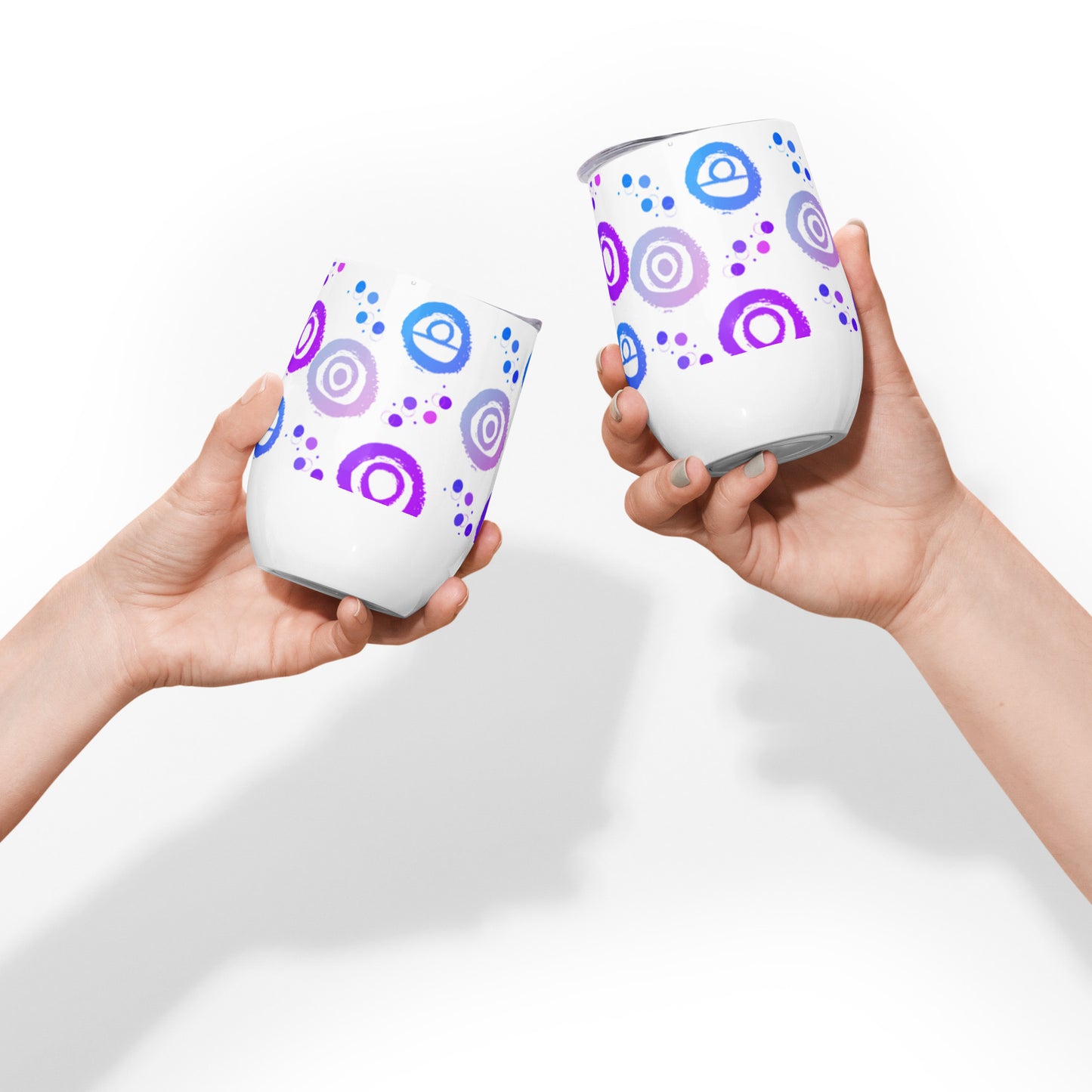 Wine tumbler in white with lid, featuring Blue, pink and Purple petroglyph designs. Front View. Two tumblers being placed in a cheers pose.