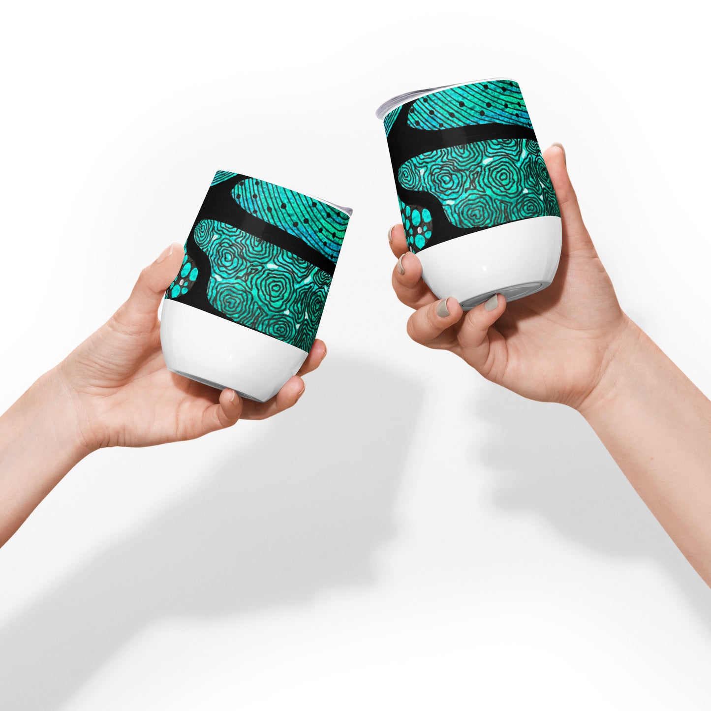 Wine tumbler in White with lid featuring beautiful black, green and white Aboriginal Artwork. Side View. Two tumblers being shown together in a cheers motions.